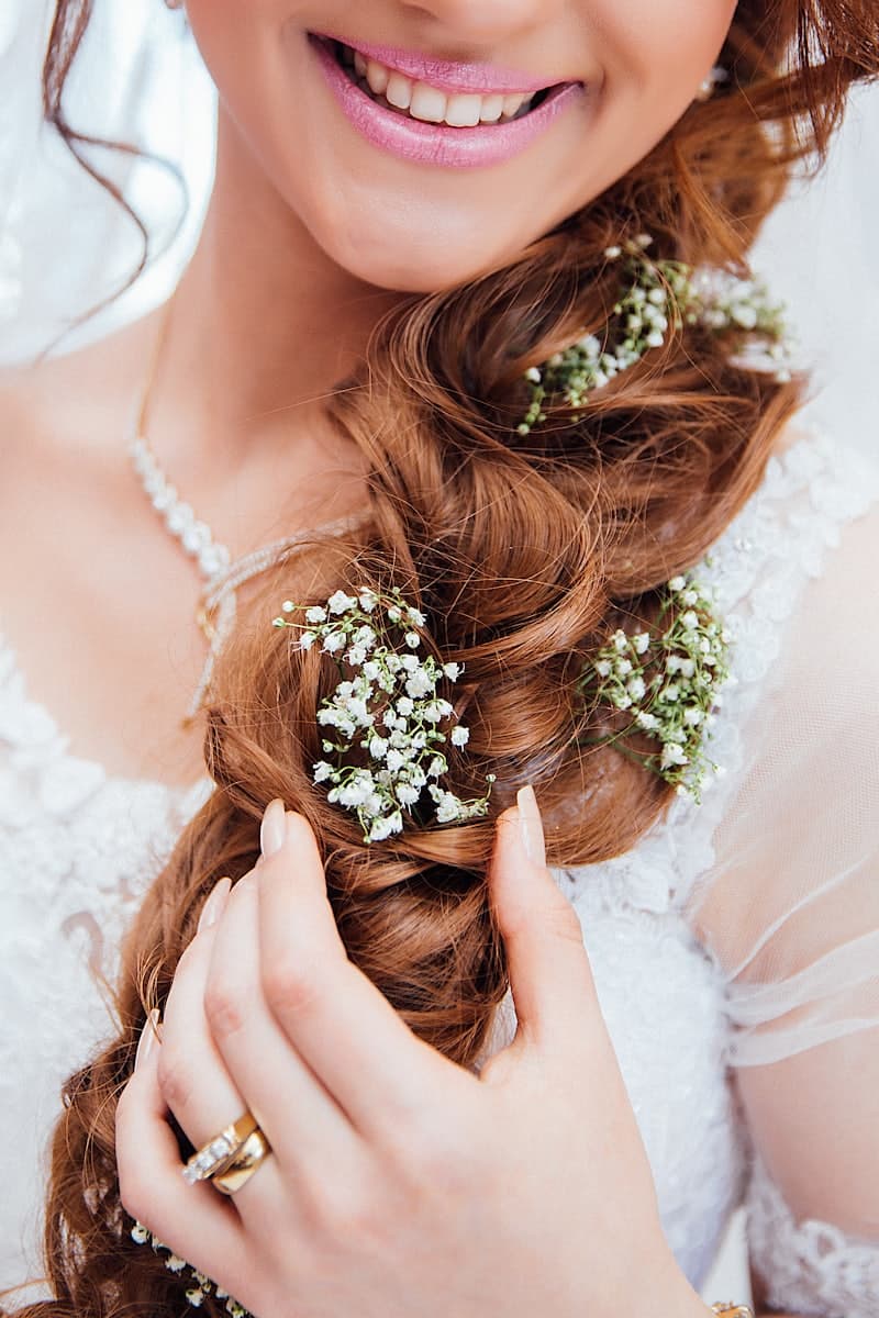 Hair styled with a fresh flower detail